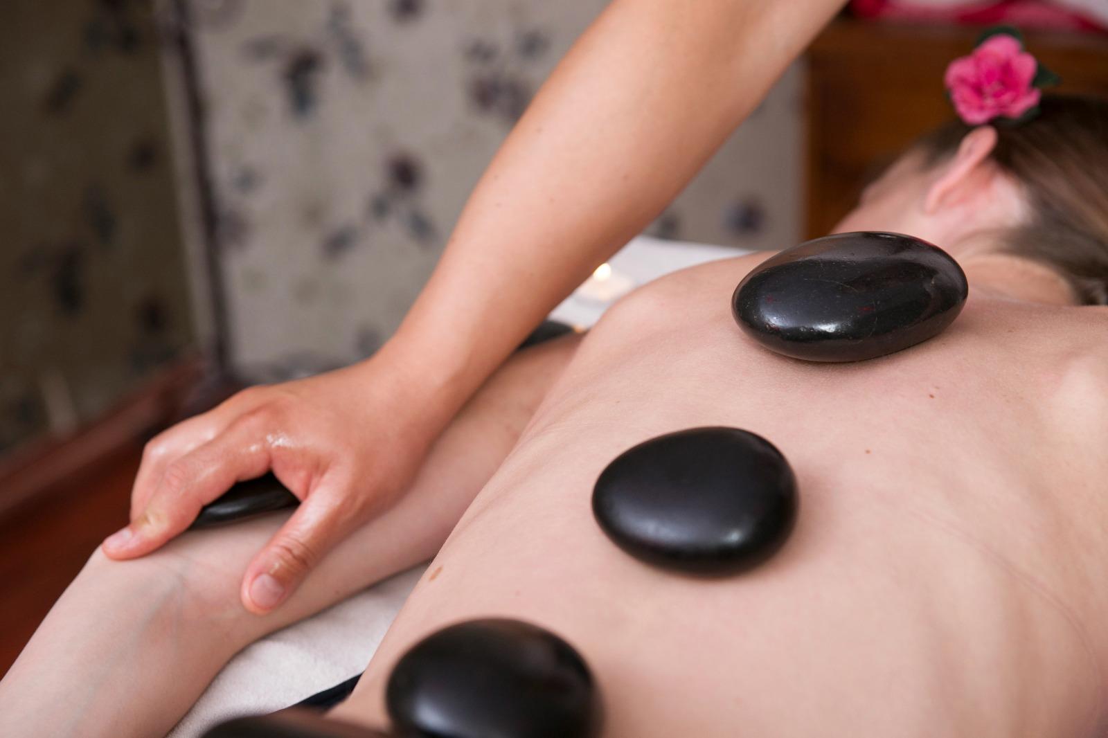 Warm stone massage at Luxe Luminary Spa in Los Angeles