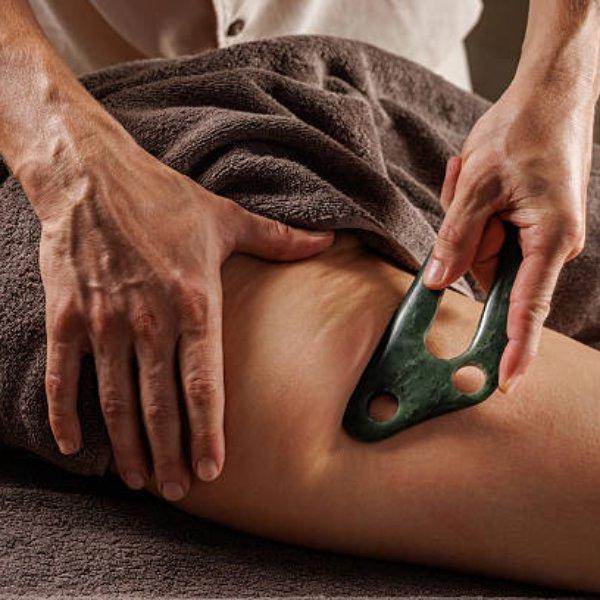 Jade blade therapy on the leg at Luxe Luminary Spa