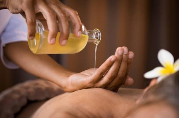 Warm massage oil prepared for a body spa treatment in Los Angeles